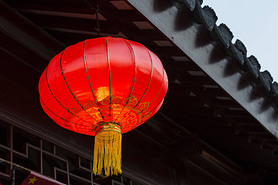 Asian lantern near national building decoration elements.