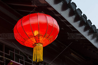 Asian lantern near national building decoration elements.