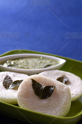 Idli with coconut chutney on blue background, Indian Dish: South Indian favorite food rava idli or s