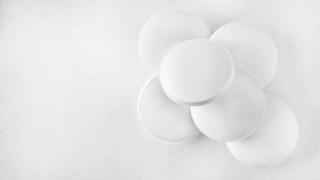 white analgesic pills on white marble background