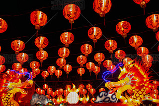 Red lanterns hanging in the black sky and god lamp at night in the Lantern Festival in Thailand.