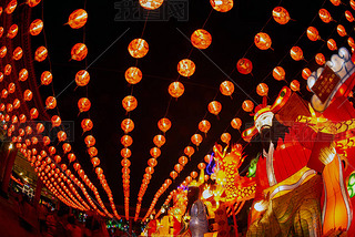 Red lanterns hanging in the black sky and god lamp at night in the Lantern Festival in Thailand.