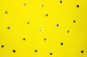 Gold round confetti on yellow background. Festive backdrop. Top view, flat lay.
