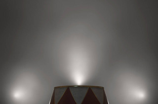 An empty circus ringmasters podium backlit by dramatic spot lights on a dark moody background - 3D r
