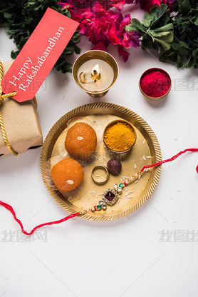 Raksha Bandhan / Rakshabandhan Rakhi with Haldi Kumkum rice, sweet Mithai, Gift Box, selective focus