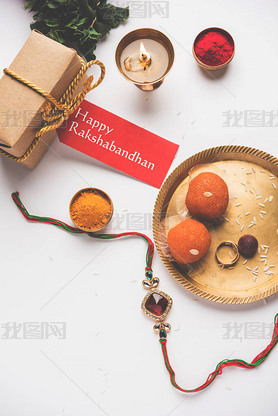 Raksha Bandhan / Rakshabandhan Rakhi with Haldi Kumkum rice, sweet Mithai, Gift Box, selective focus