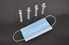 Disposable syringes and medical mask.