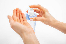 Disinfection of hands. Man applying antiseptic spray to his hands to prevent coronavirus or flu, on 