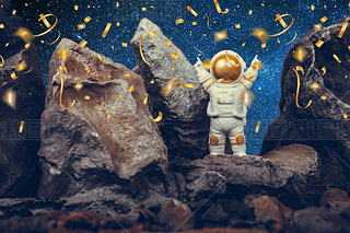 Astronaut standing on rocky mountain celebrating with raising arms while falling shiny golden confet