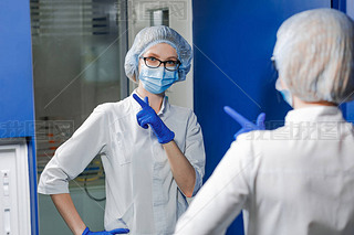 Dentist wearing a medical mask and blue gloves.