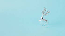 Winter arrangement made of silver reindeer on a blue background. Minimal Christmas concept. New Year