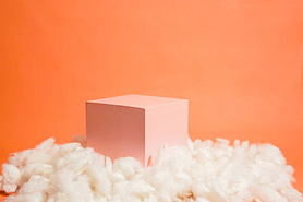 product platform arrangement in pink pastel color decorated with cotton as clouds. trendy display la