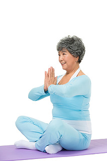 老年女人坐在瑜伽垫上