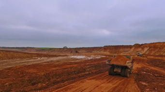 Dumpertruckmovingalongsandquarry.Aerialviewofdumptruck