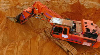 Orangecrawlerexcavatorstandingonsandmine.Miningexcavator