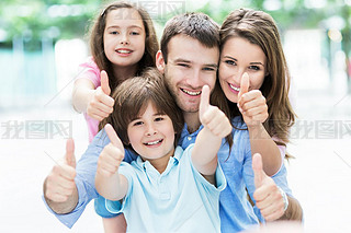 Happy young family thumbs up