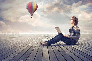 Young man on  floor using a laptop