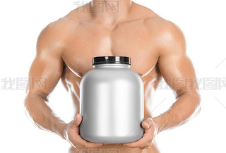 Bodybuilding and Sports theme: handsome strong bodybuilder holding a plastic jar with a dry protein 