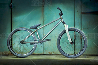 Silver bicycle on a green garage background
