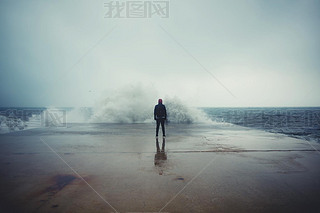 Rear view of man standing on the pier