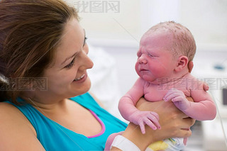 Young mother giving birth to a baby