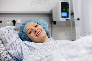 Young woman in hospital recovery room after surgery