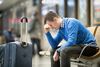 Young frustrated man at airport