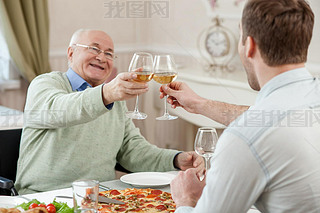 Cheerful family is celebrating with alcohol drink