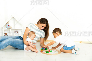 Mother Sitting With kids playing game Indoors