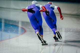 closeup two men skaters synchronous running