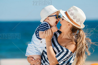 A young mother and her delightful little son on vacation at the beach