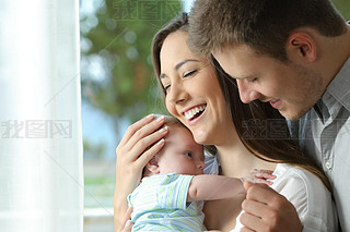 Proud parents holding their baby