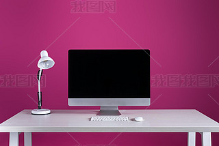 desktop computer with blank screen, keyboard, computer mouse and lamp at workplace