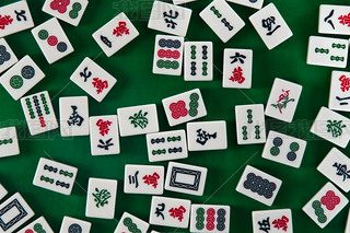 White-green tiles for mahjong on on green cloth background