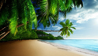 sunset on beach Anse Takamaka of Mahe island, seychelles