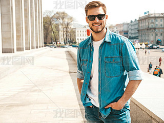 Portrait of handsome iling stylish hipster lumberual businesan model. Man dressed in jeans ja