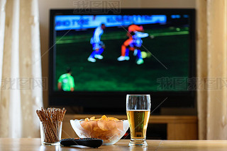 television, TV watching (football, soccer match) with snacks lyi