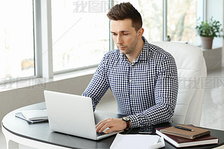 Handsome businesan working in office