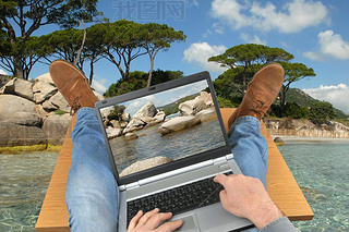 Concept of working on a laptop at the beach