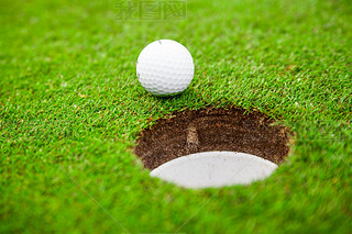 Golf ball on green meadow