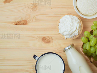 Milk and cheese, dairy products, fruits on wooden background. Jewish holiday Shuot concept. Top vi