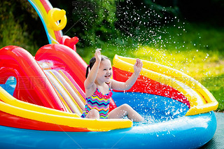 Little girl in garden swimming pool