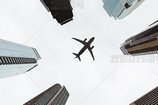 bottom view of skyscrapers and clear sky with airplane in new york city, usa