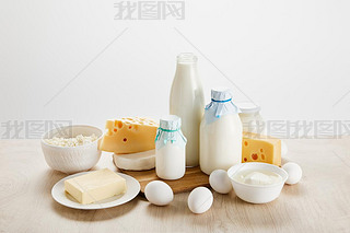 various fresh organic dairy products and eggs on wooden table isolated on white