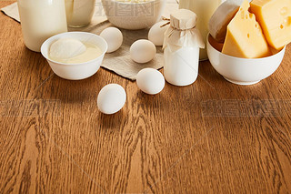 various fresh organic dairy products and eggs on rustic wooden table