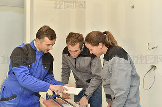 Teacher with students using saw