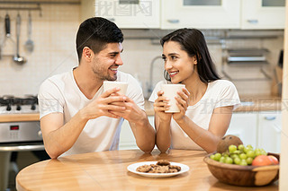 Lovely family enjoying breakfast together at their apartment