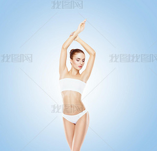 Sporty girl posing in swimsuit on blue background. Sport, fitness, nutrition and beautiful body shap