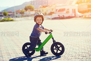 Little boy riding a runbike