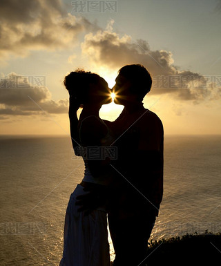 Silhouette of a young couple at sunset